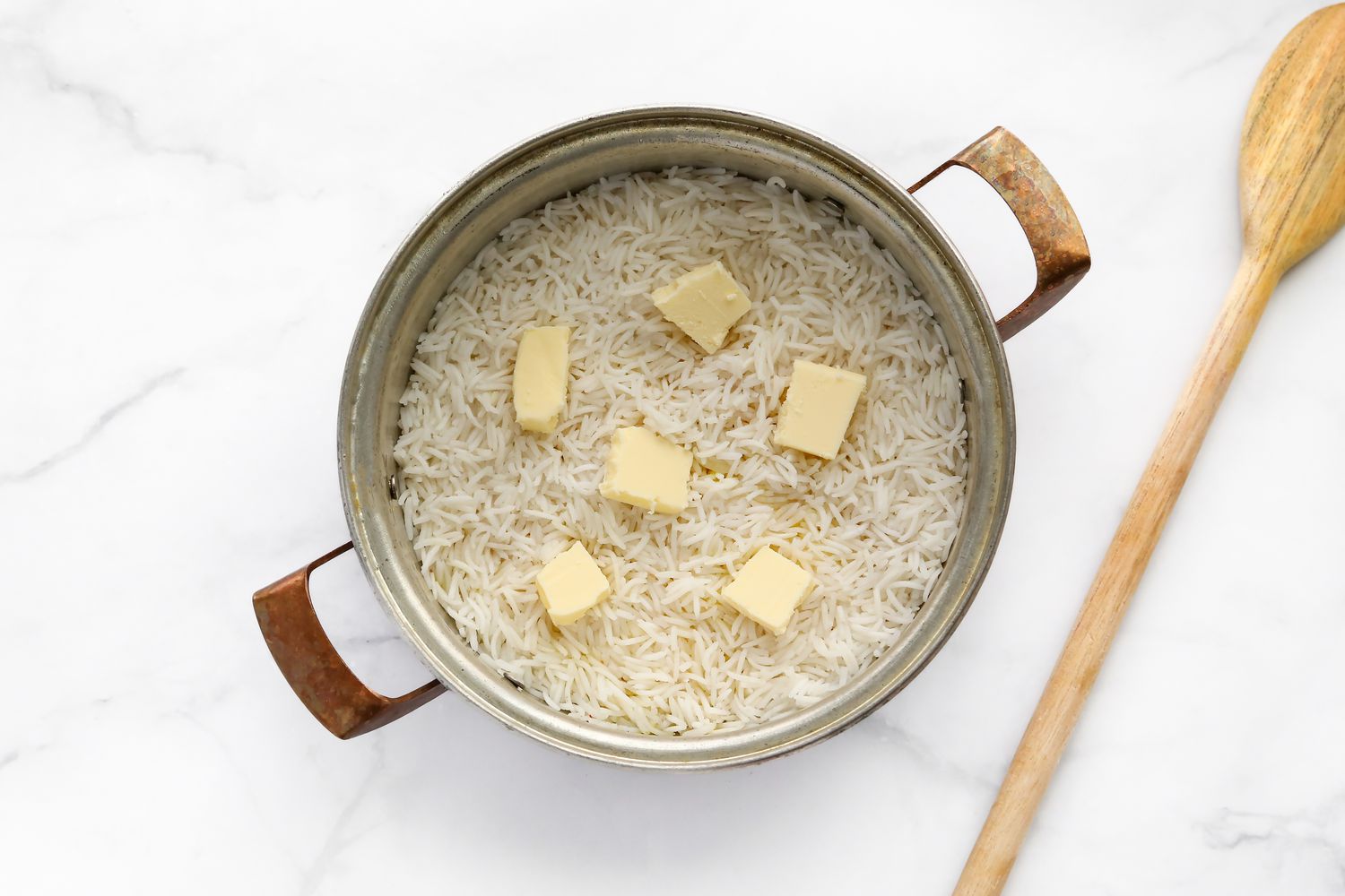 Basmati Rice Added to Pot and Topped with Cubes of Butter 