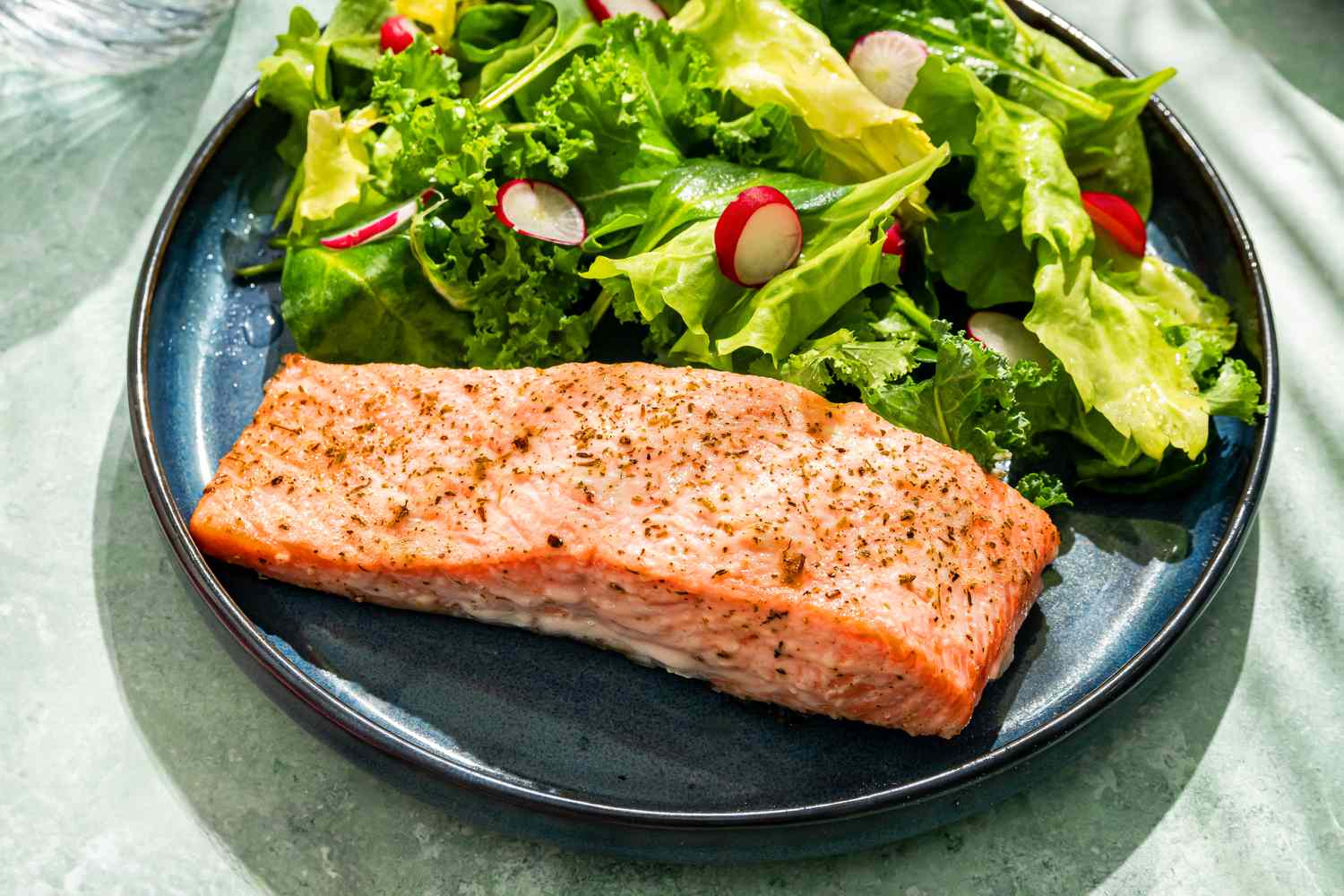 2-ingredient salmon fillet with a side green salad on a plate