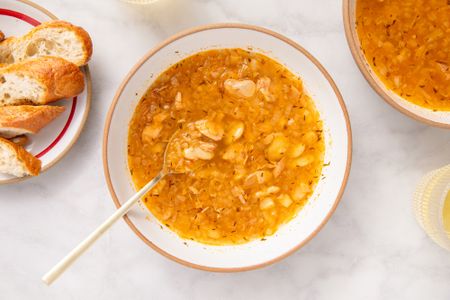 15-Minute Tuna and Butter Bean Stew in a bowl with spoon, bread on the side