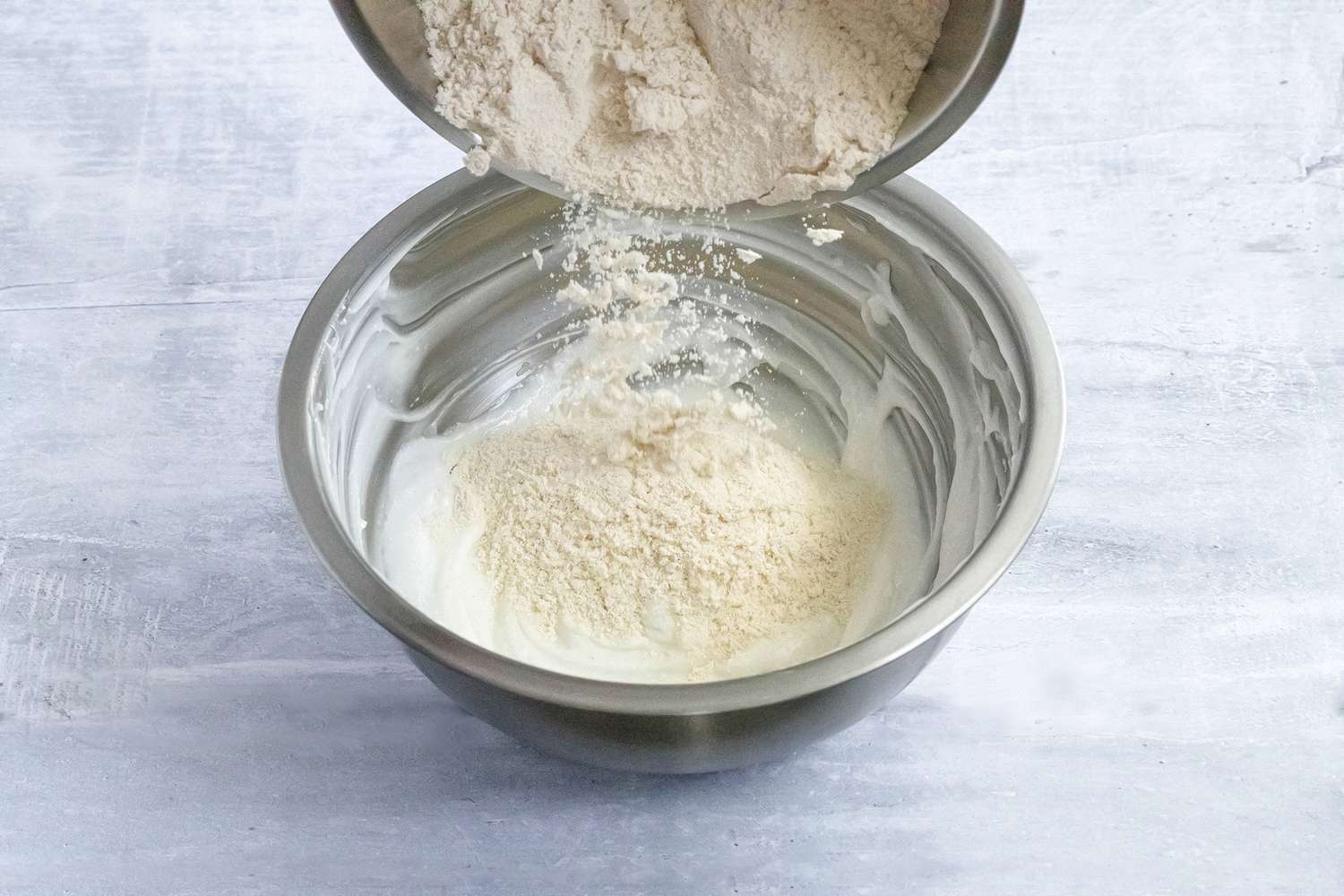 Masa Harina Added to Bowl of Mixed Lard for Tamales Dough Recipe