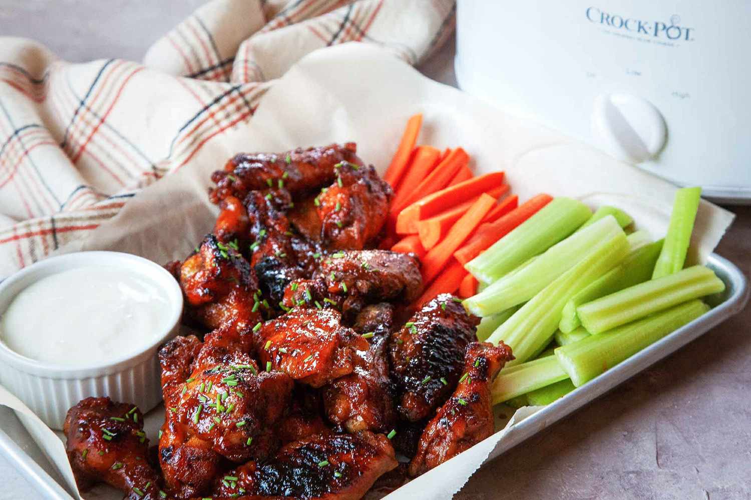 Honey buffalo chicken wings cooked in a crock pot and served with blue cheese dressing