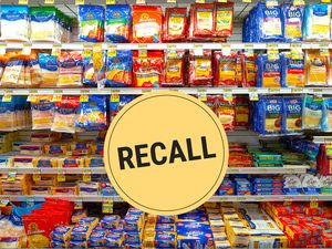 Supermarket cheese section with a recall alert badge displayed