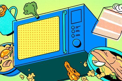 Blue microwave with several foods around it