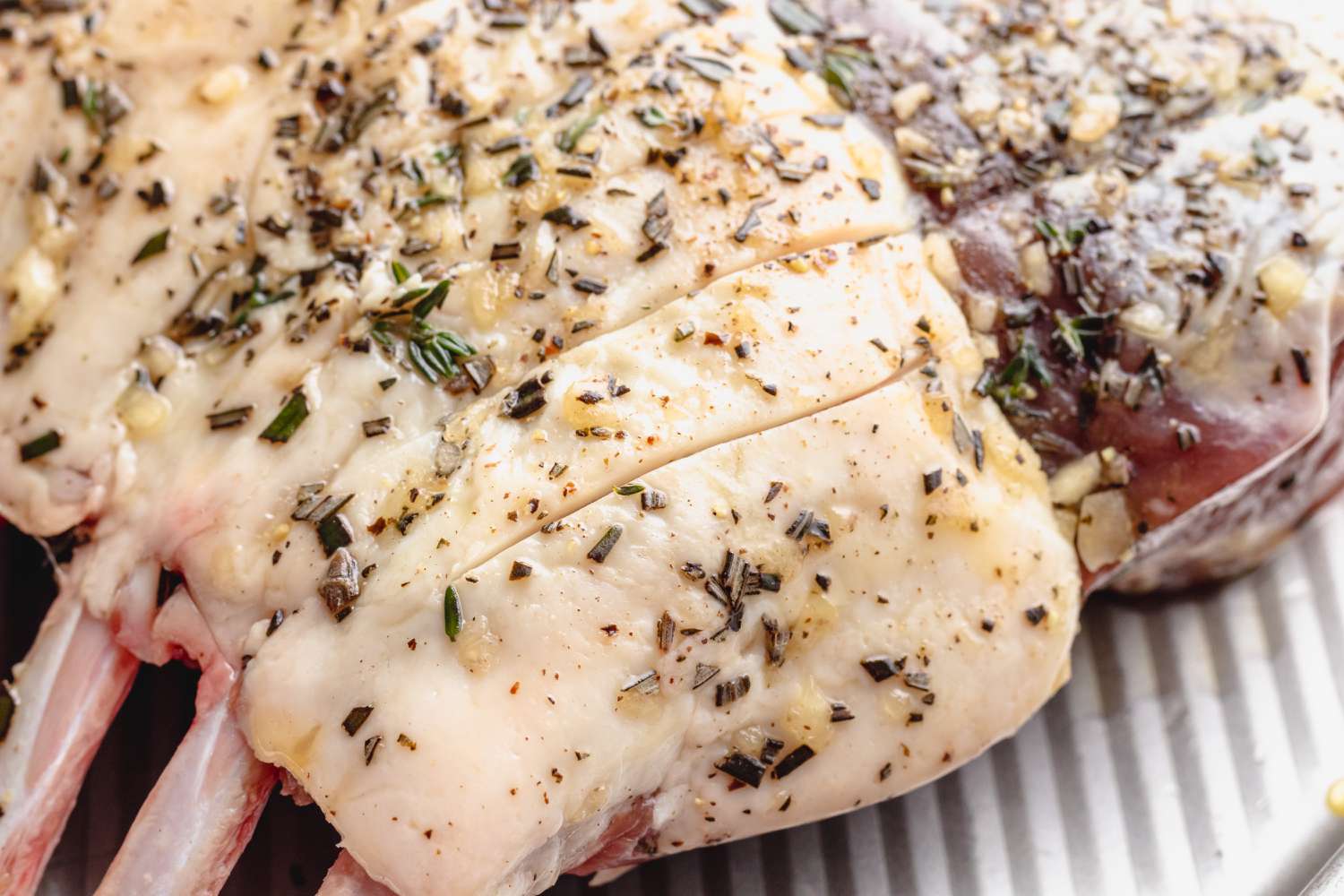 Method shot - scored raw rack of lamb marinated closeup