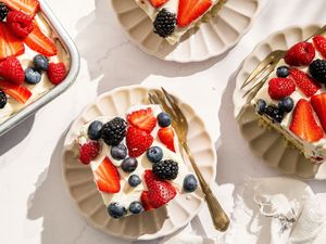 slices of Easy Berry Chantilly Cake on small plates with forks