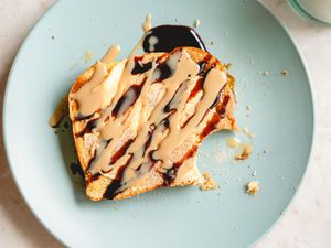 Plate of Tahini Cinnamon Toast with one bite taken out of it