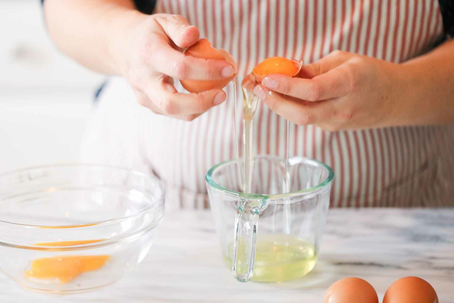 Separating the egg whites into a measuring glass