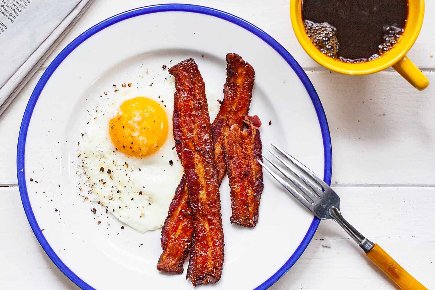 fried egg with bacon on a plate