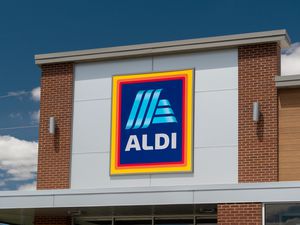 A sign for an Aldi grocery store on a building