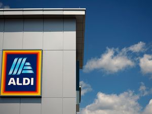 Aldi store with logo against a blue sky with clouds
