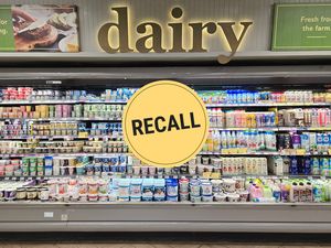 Supermarket dairy section with a recall notice displayed