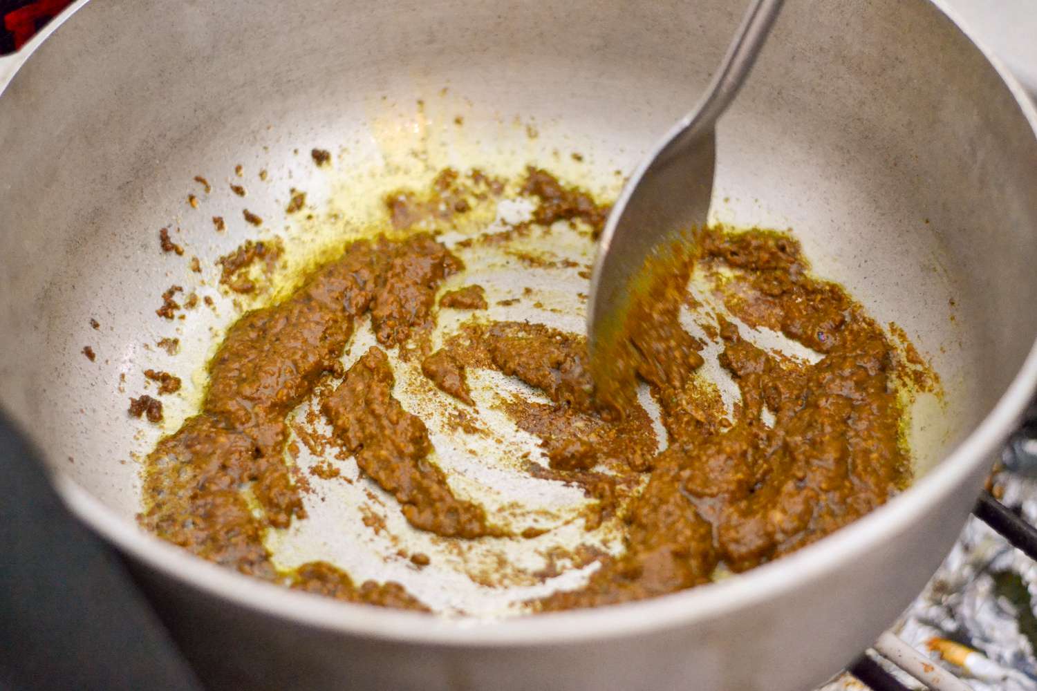 Cook Curry Paste in Pot for Guyanese Chicken Curry