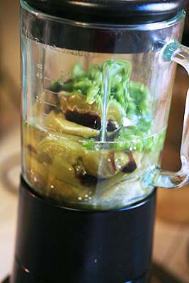 Tomatillos with garlic, jalapeño, cilantro resting in a blender