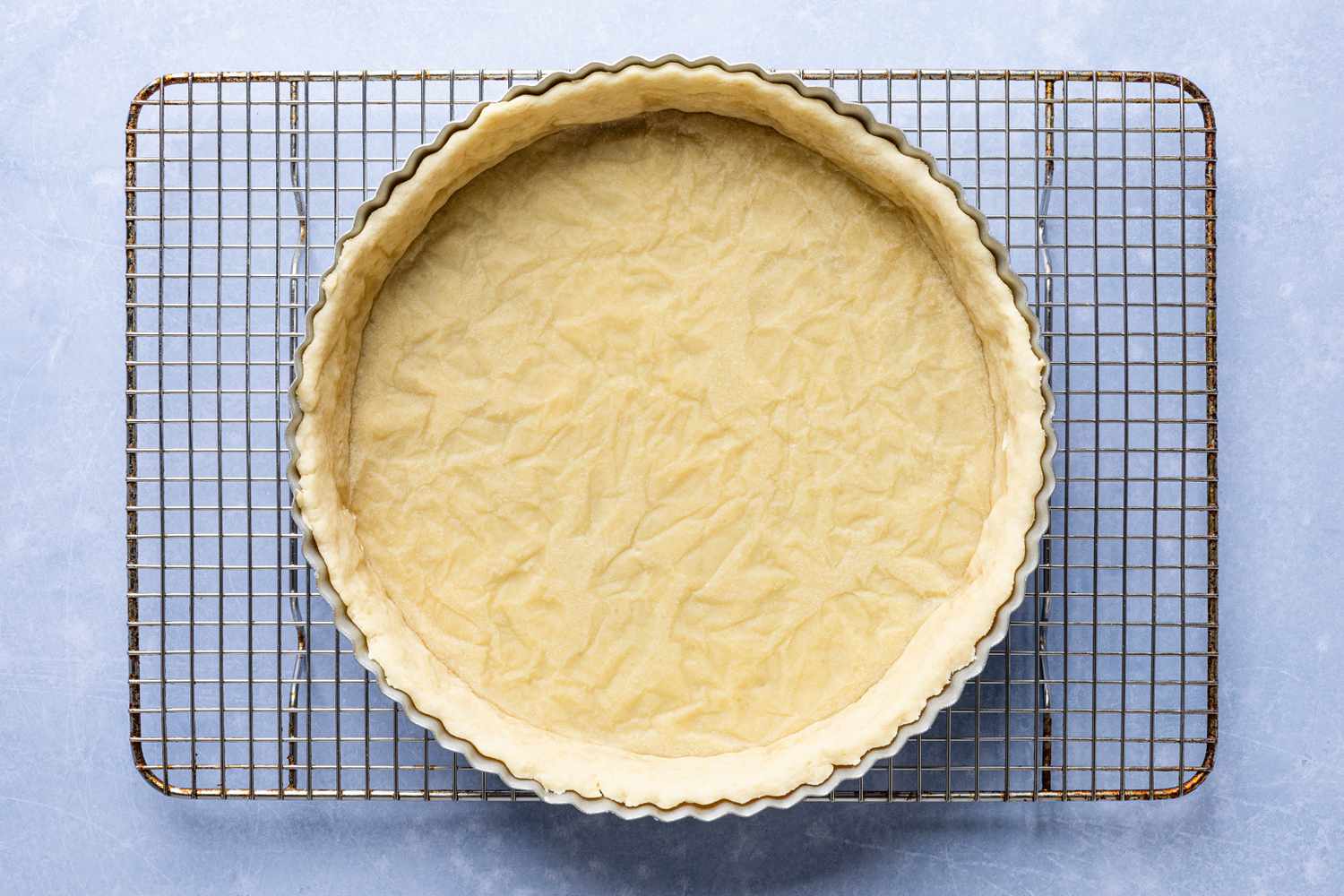 fully baked tart shell (after second bake) on cooling rack for cornflake tart recipe
