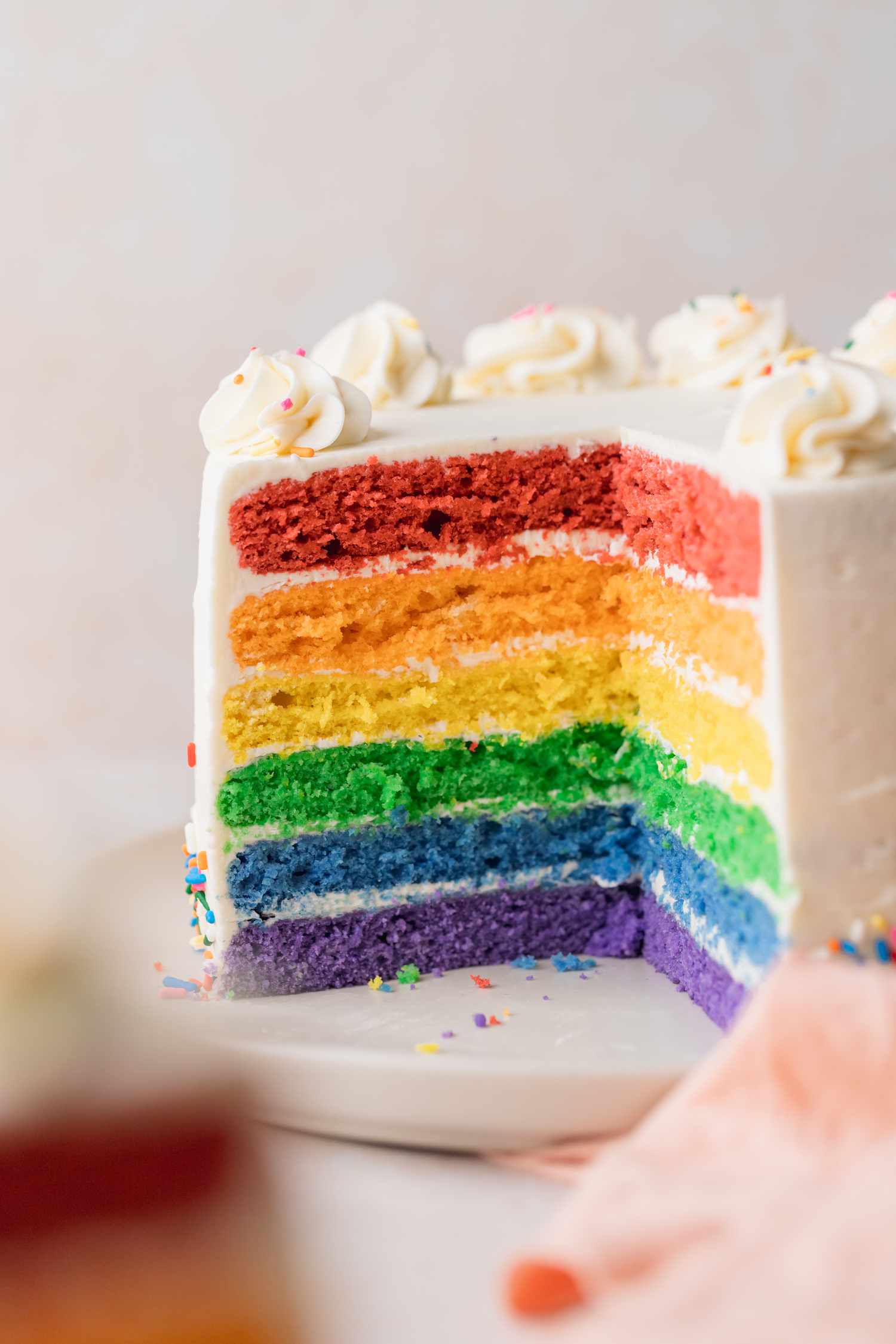 Roygbiv Layer Cake on a Plate with a Portion Cut Out