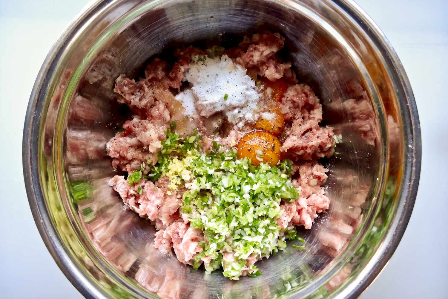 Overhead view of pork and ingredients to make the filling for easy wonton soup.