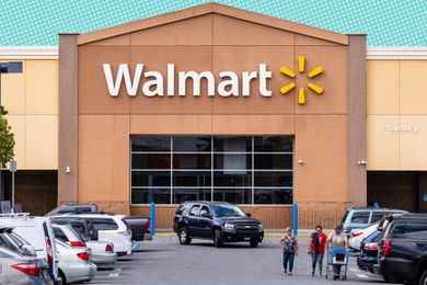 Walmart store exterior with parked vehicles and people walking