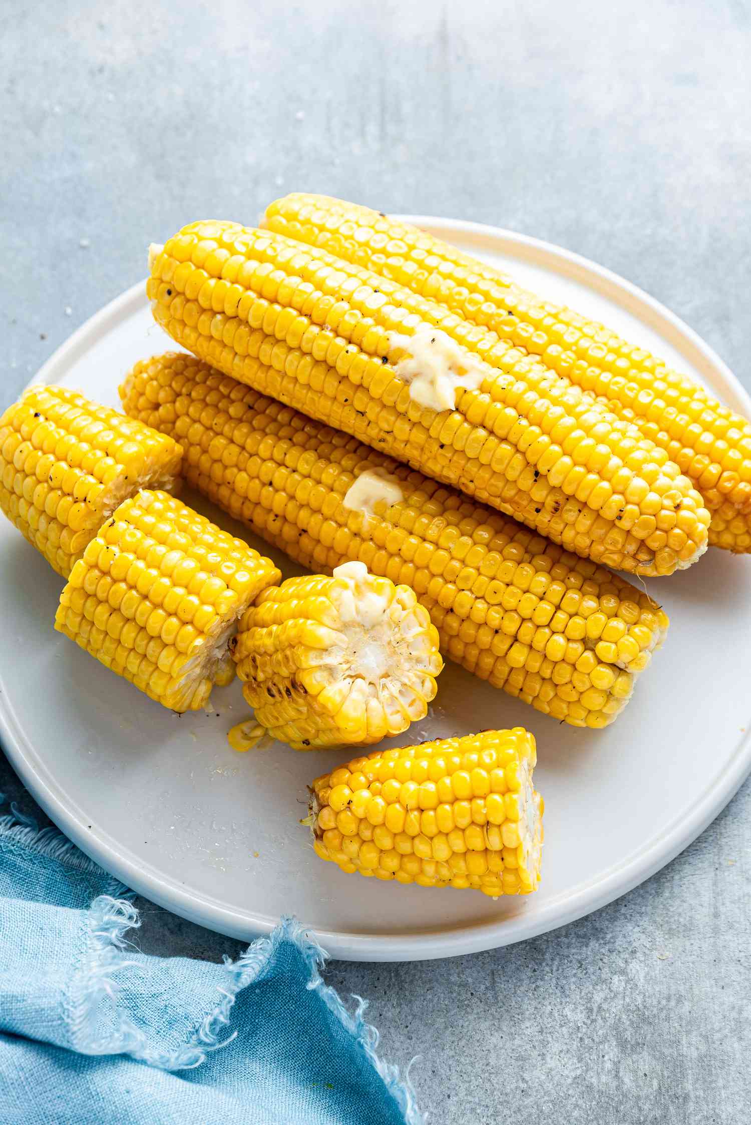 A Plate of Grilled Corn on the Cob Slathered with Butter