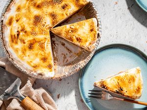 A frozen smores pie with a missing slice served on a blue plate