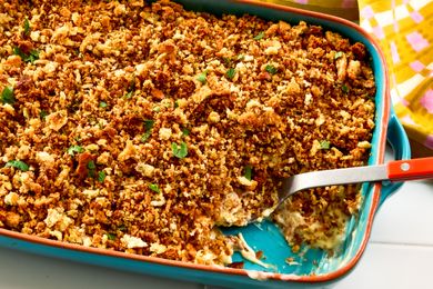 Chicken stuffing casserole in a baking dish with a serving spoon visible