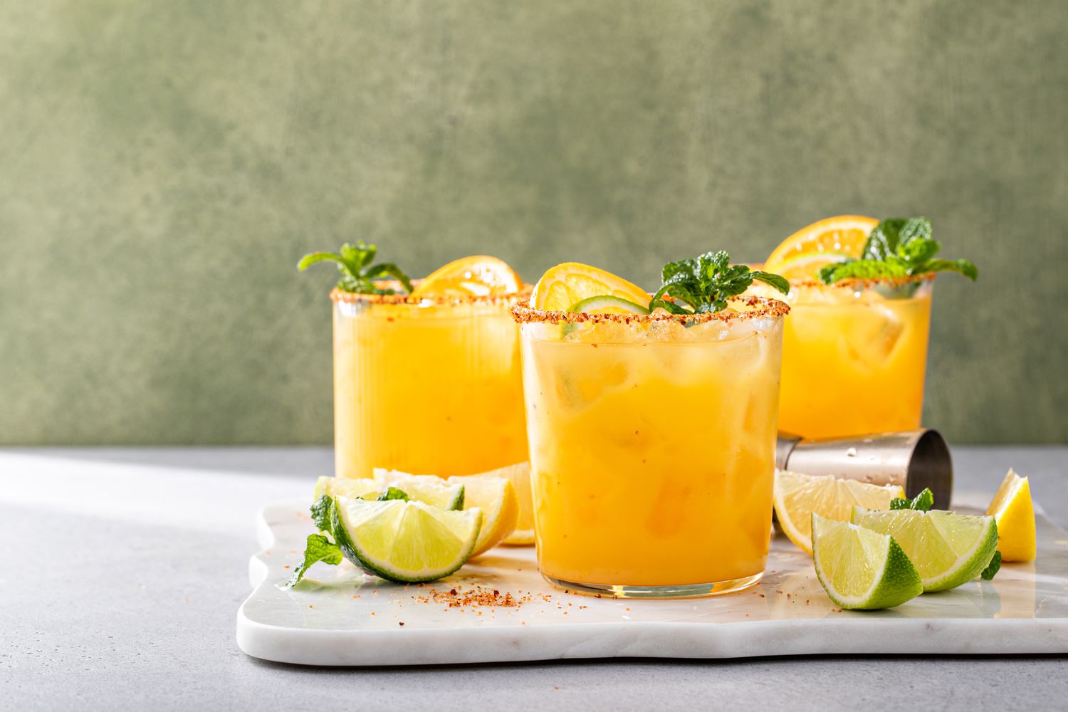 glasses of margaritas on a marble tray