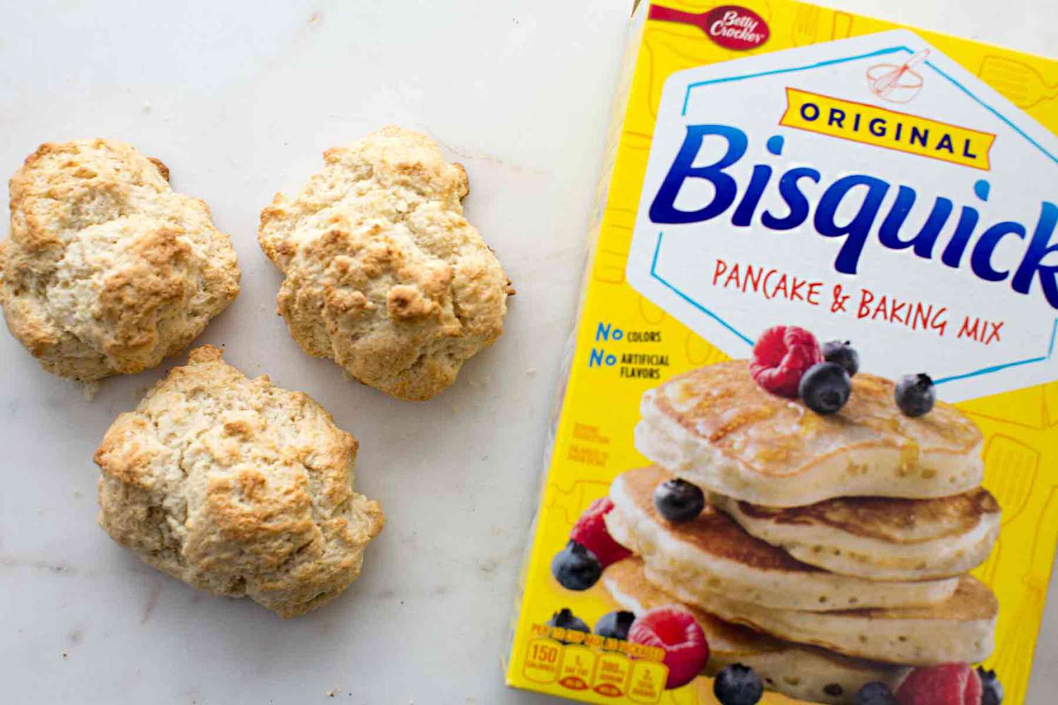 Bisquick shortcake biscuits sitting next to a box of Bisquick baking mix