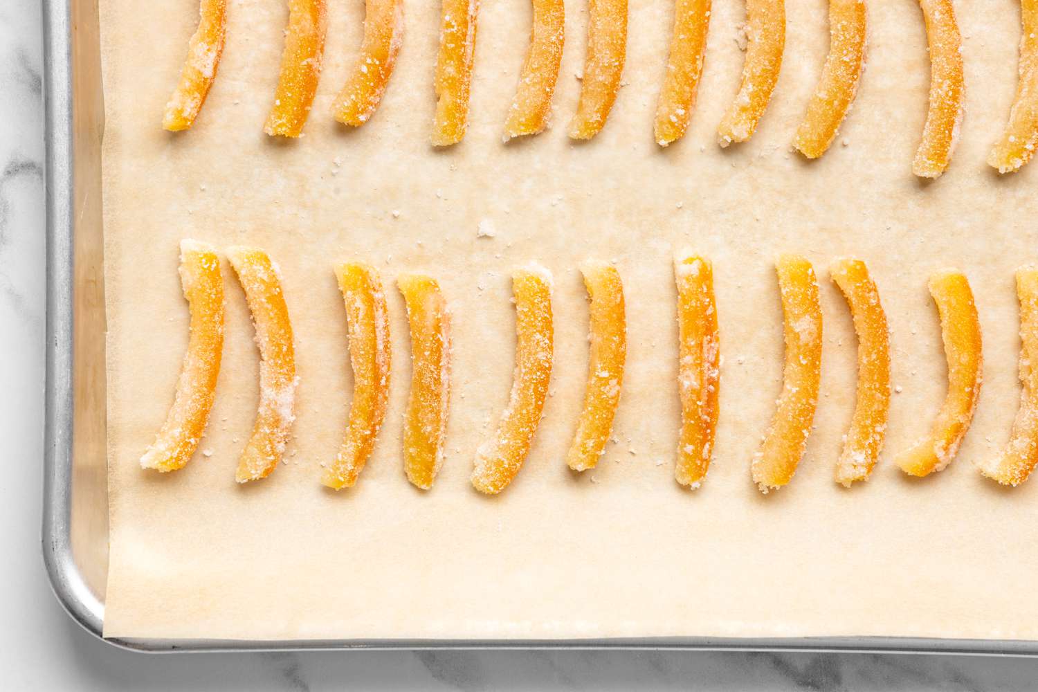 Orange Pieces Dried on a Lined Baking Pan for Orangettes Recipe