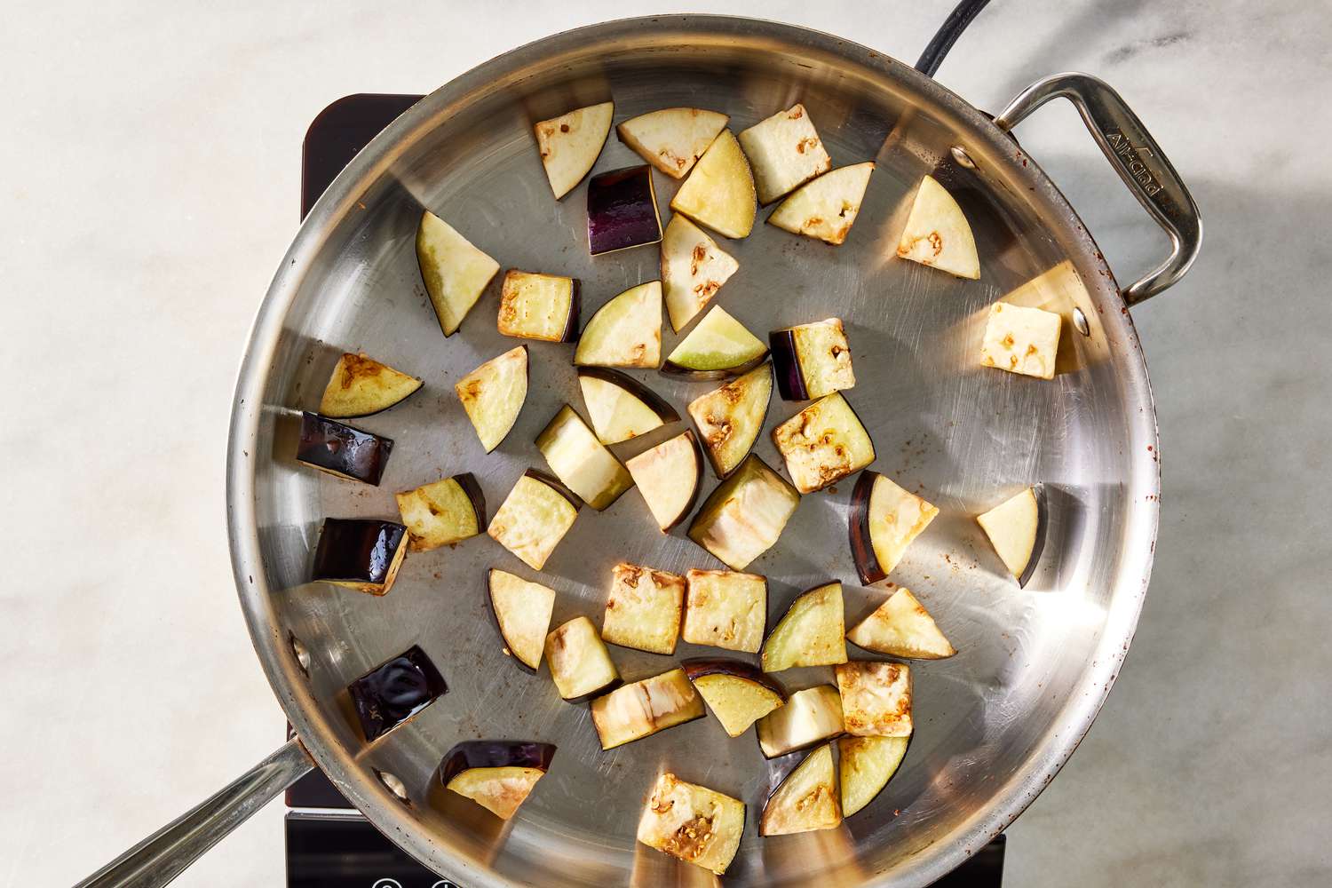 slices of eggplants seared in a pot for pasta alla norma recipe