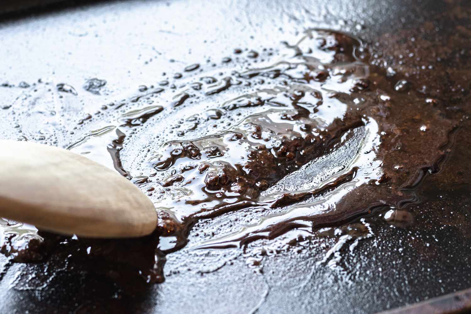 Scraping drippings off the pan to make a roast beef recipe.