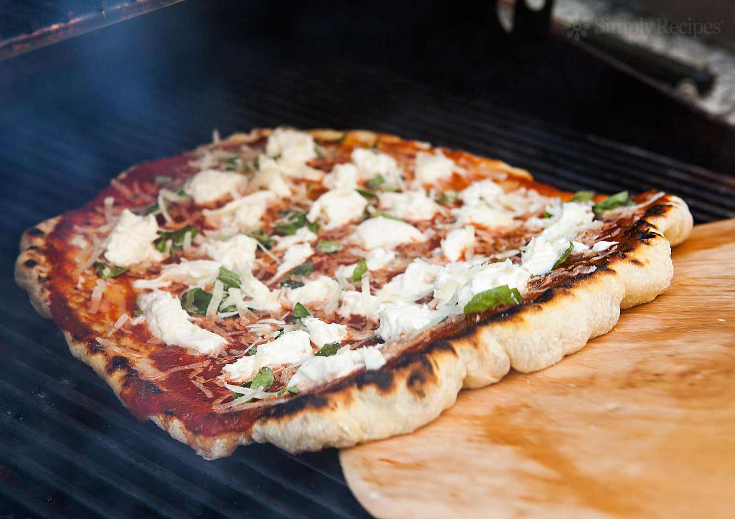 pizza coming off the grill