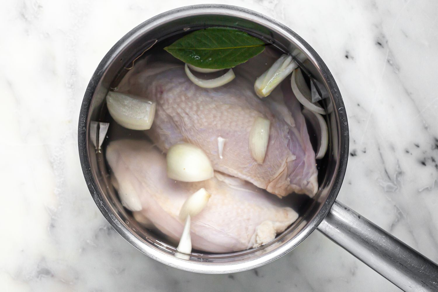 Chicken Boiled in a Pot of Water with a Bay Leaf and Onions for Chicken Lasagna Recipe