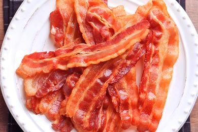 Cooked bacon strips arranged on a plate