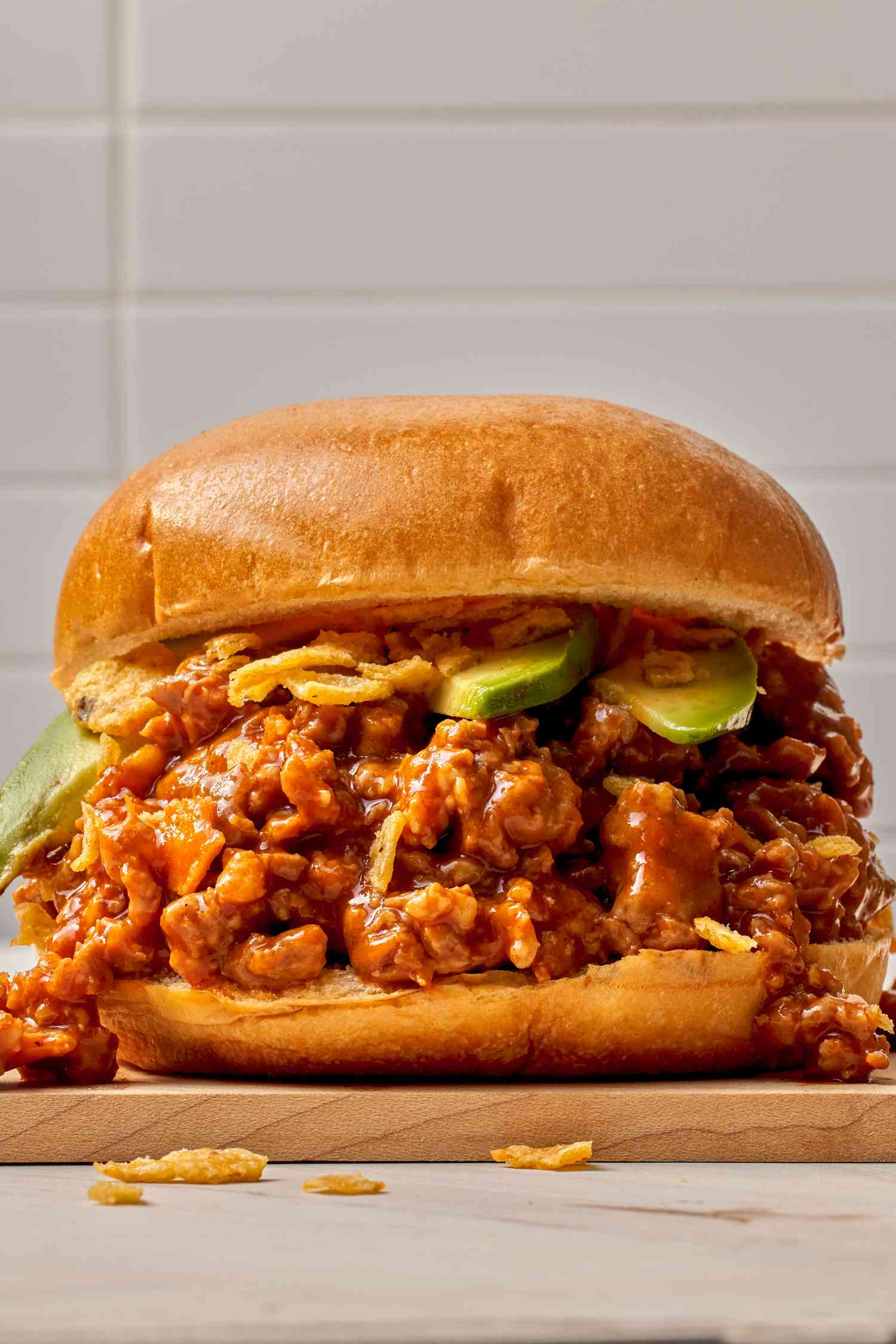 Close-up: chorizo sloppy joe ith a few avocado slices and a crushed fritos