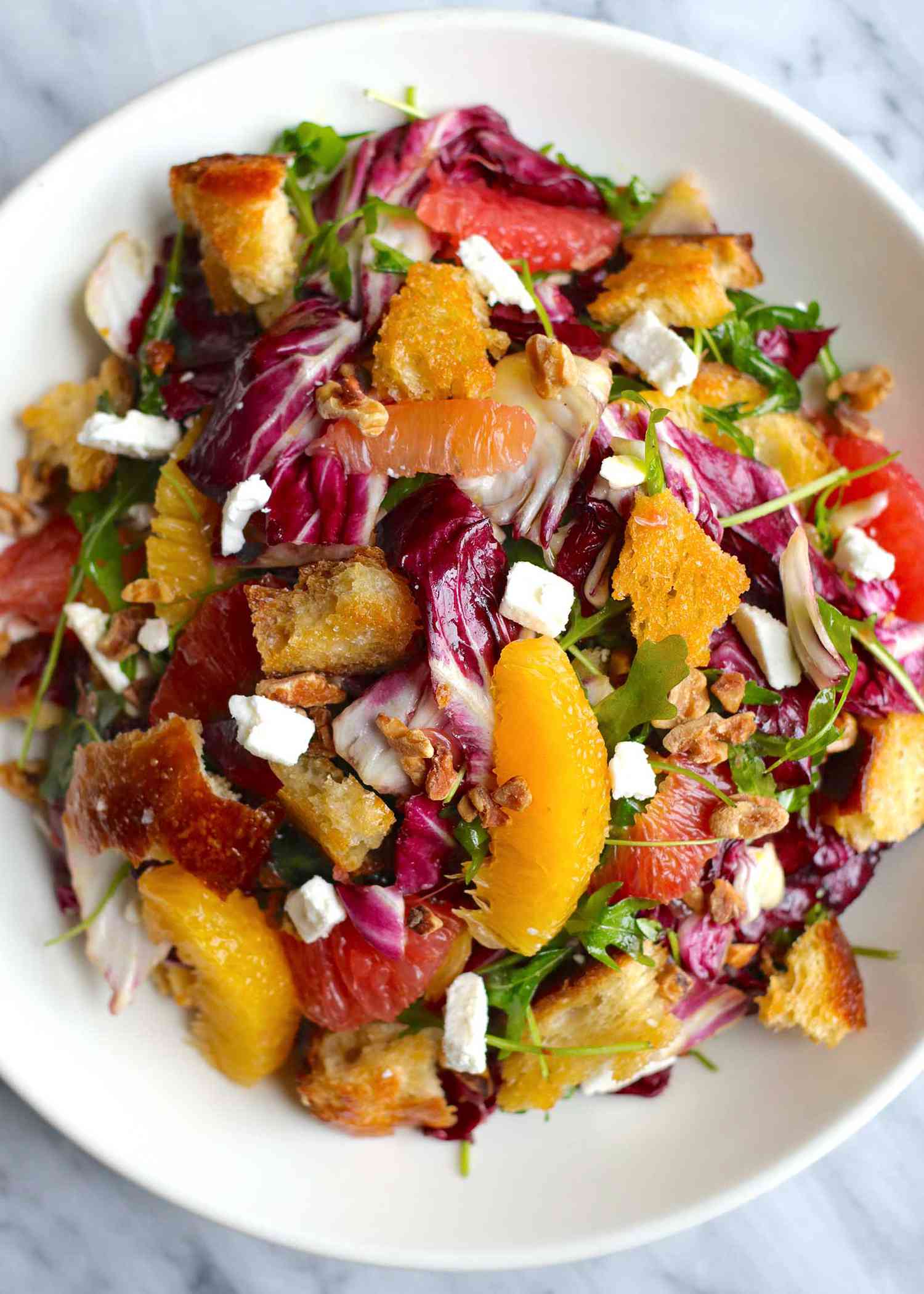 Citrus Salad on a White Plate with Orange and Grapefruit Slices, Radicchio, Croutons, and Feta Cheese Crumbles