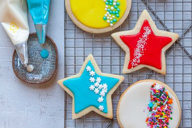 Royal icing for sugar cookies decorated and set on a cooling rack.