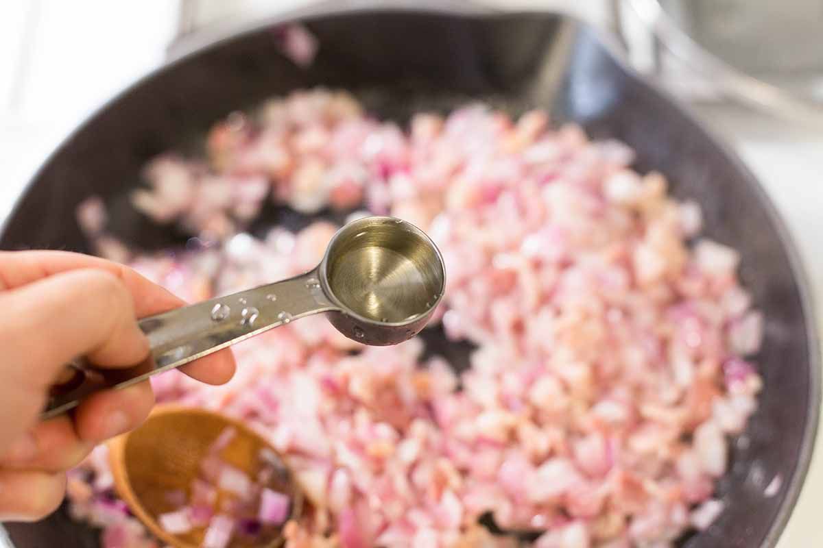 Add vinegar to the onions for German Potato Salad