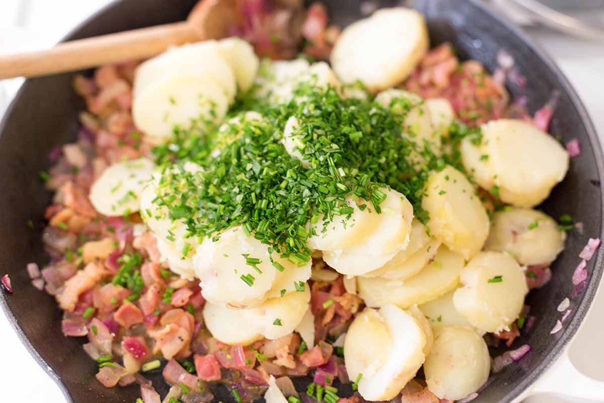 Stir the cooked and sliced potatoes into the bacon vinaigrette to make German Potato Salad
