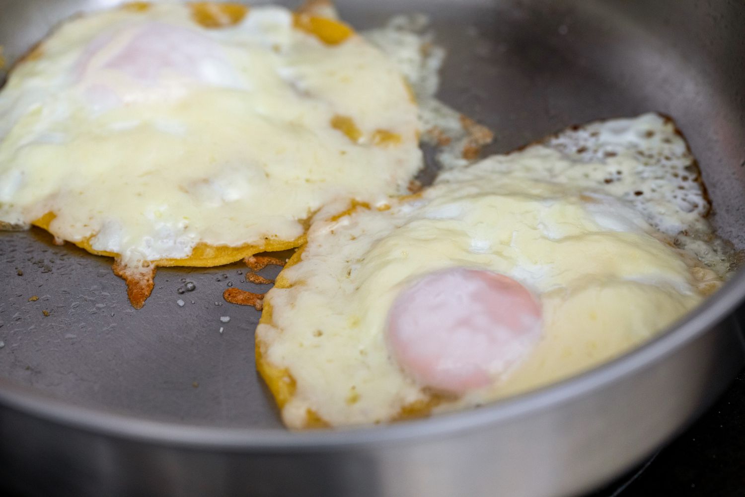 Tortilla, melted cheese, and eggs for fried egg taco