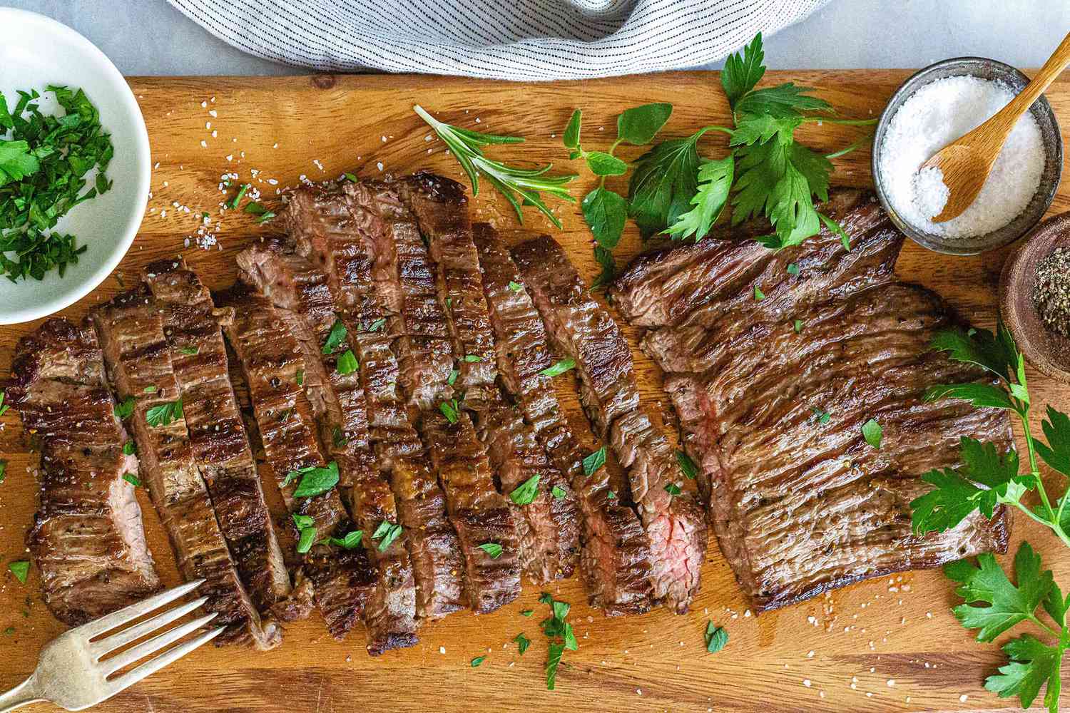 A cutting board with sliced skirt steak, ready to serve