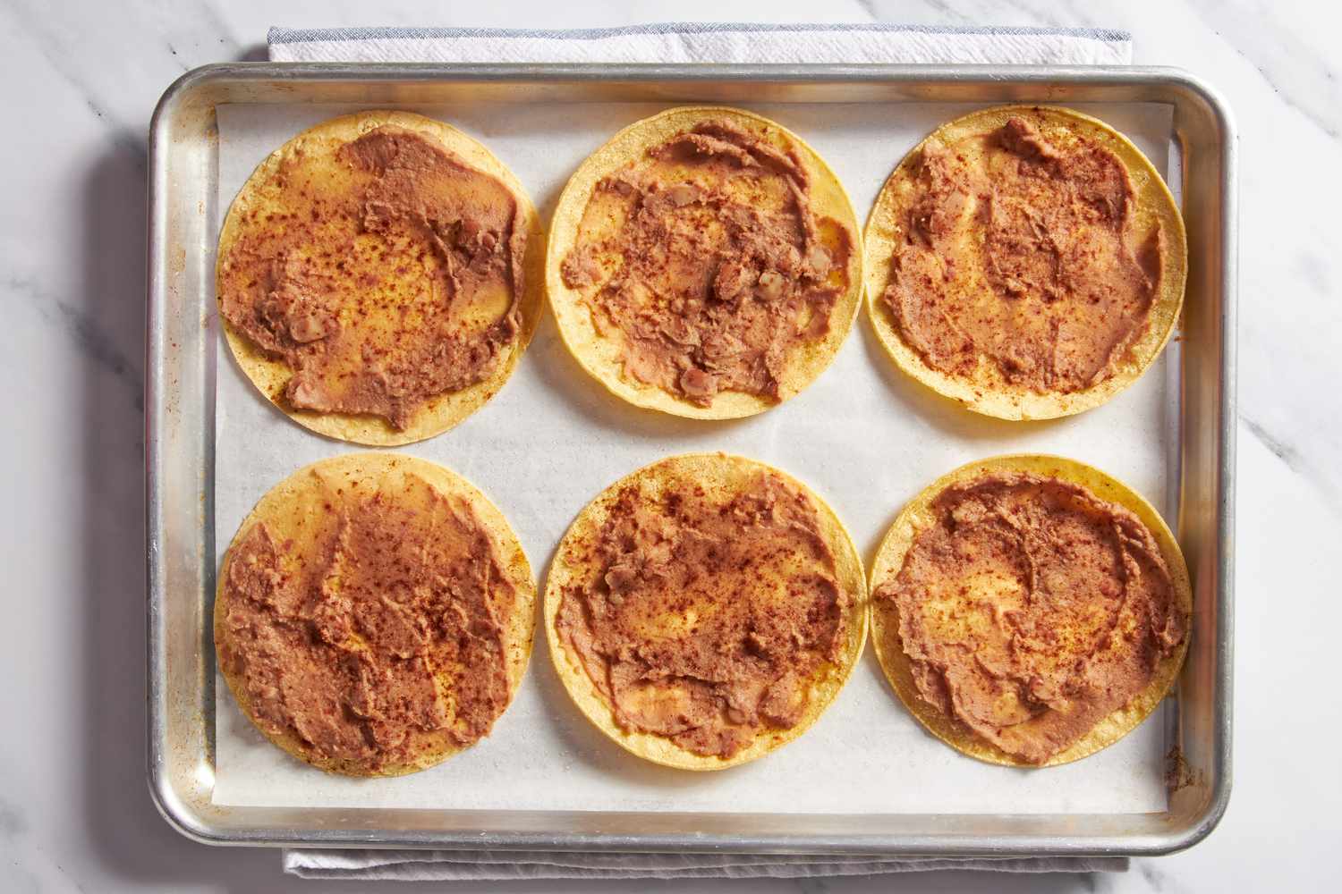 Toasted seasoned tacos on a baking sheet for cheesy baked taco recipe