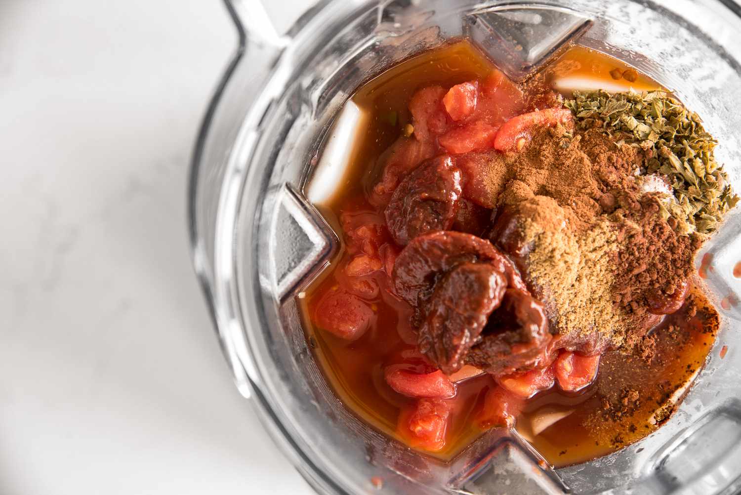 Canned Tomatoes and Spices Added to Blender for Enchilada Sauce Recipe