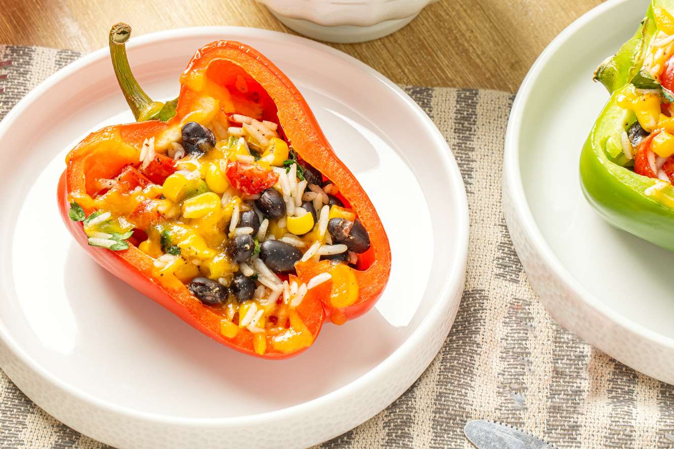 Stuffed bell peppers with rice beans corn and cheese on a plate