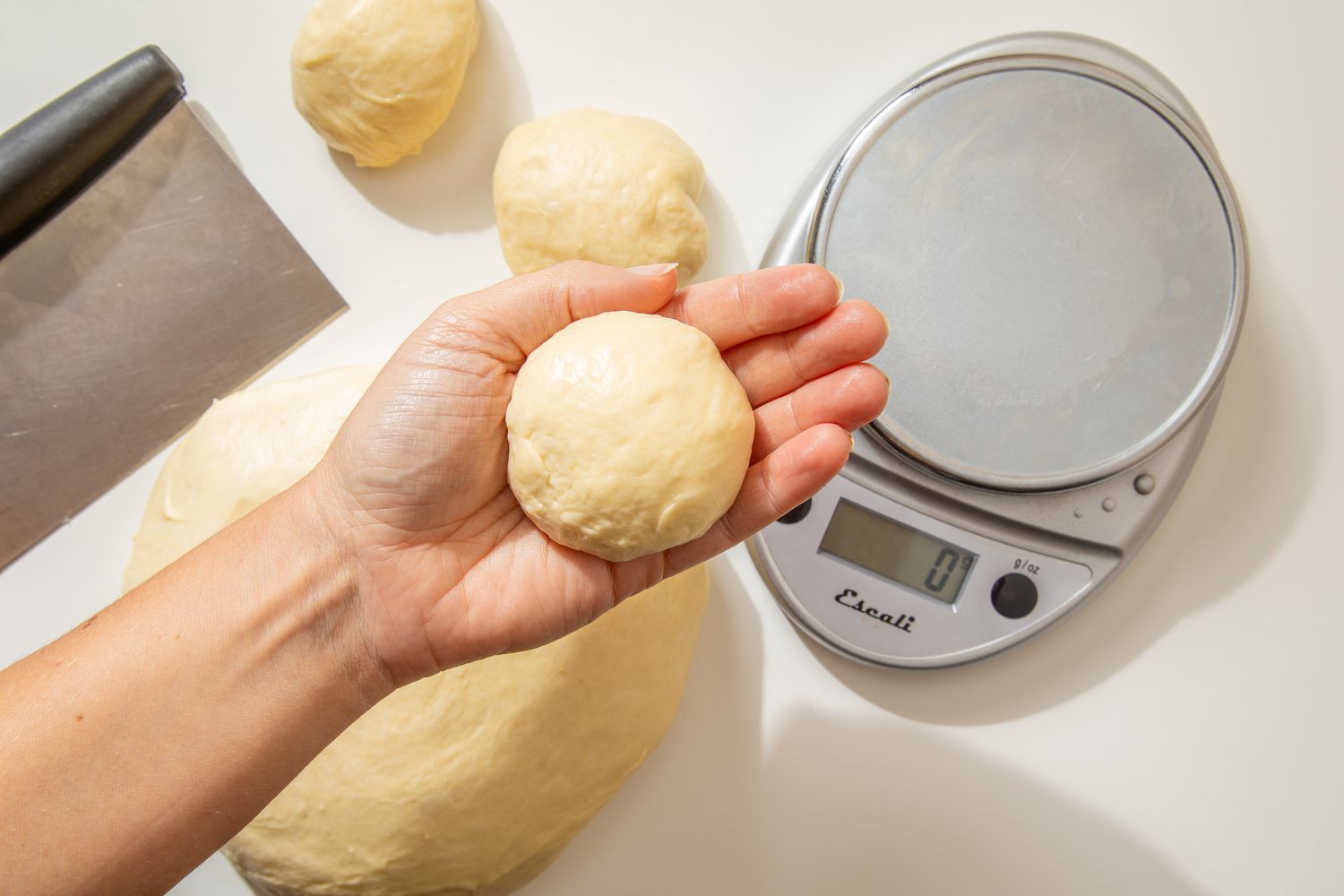 Shaping the roll: roll flipped and shaped into a round ball for salted honey rolls recipe