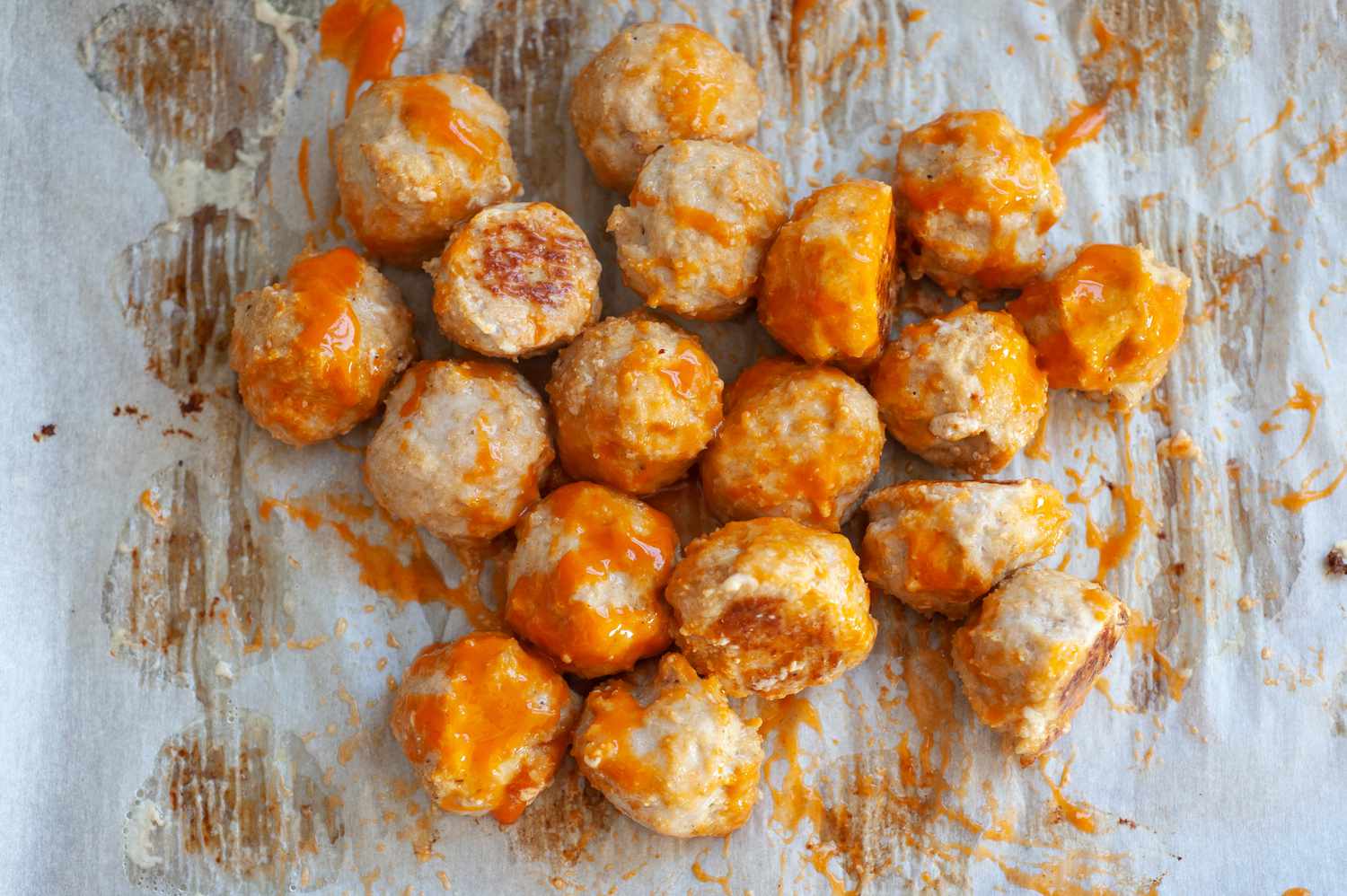 Buffalo chicken meatballs on baking sheet. 