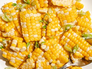 Cooked corn cut into pieces with sliced green onions