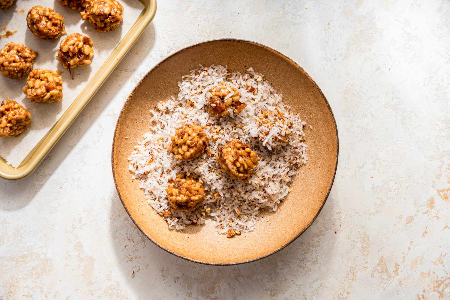 Date skillet cookies rolled in a shredded coconut and pecan mixture