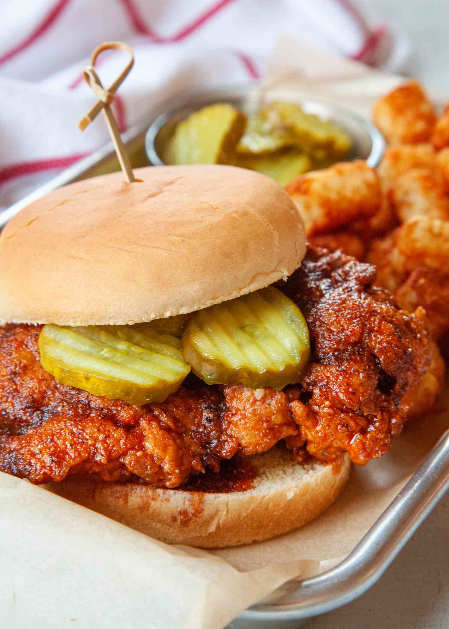 Nashville-style hot chicken served on a parchment lined tray.
