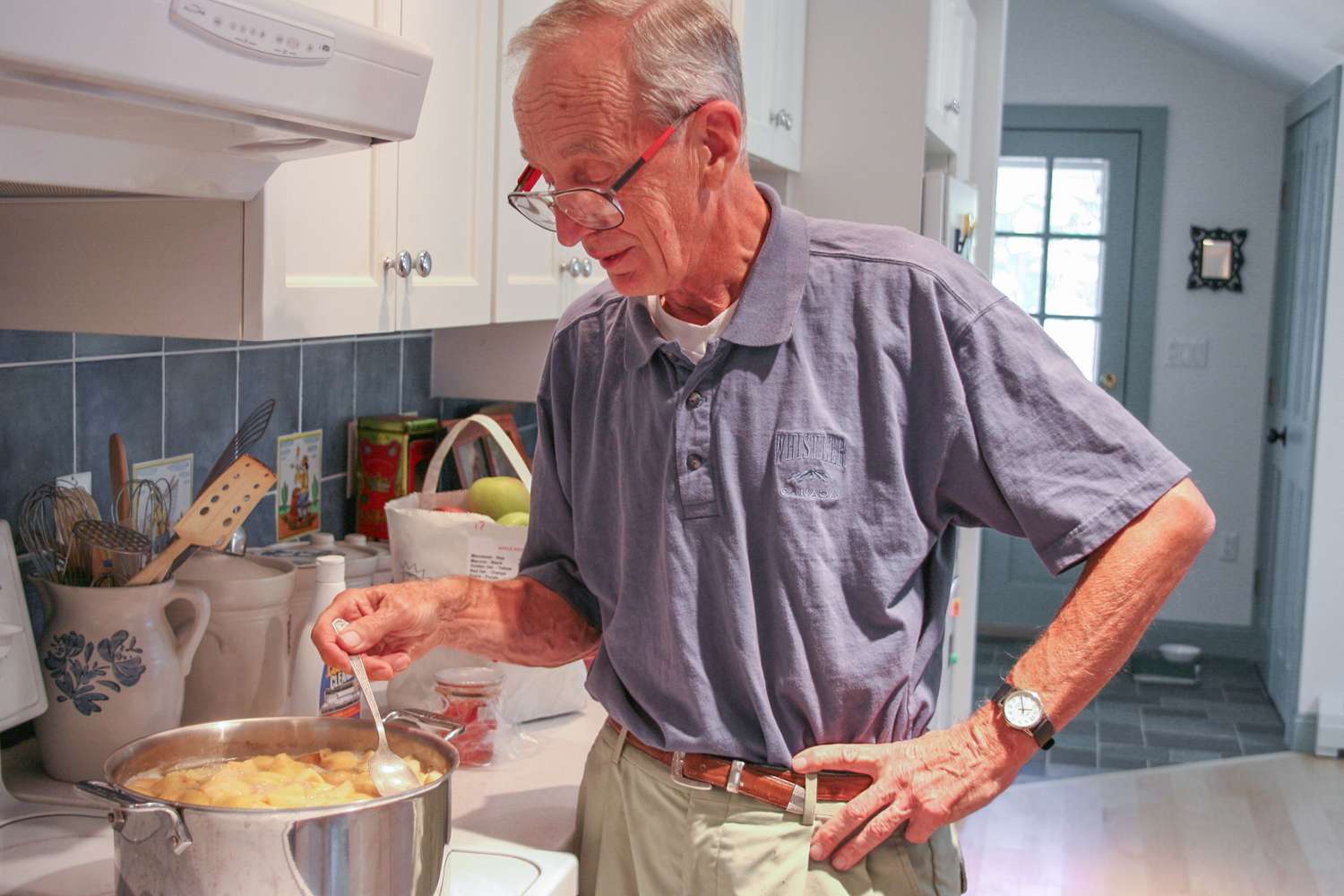 A man named George making quince jelly in a kitchen