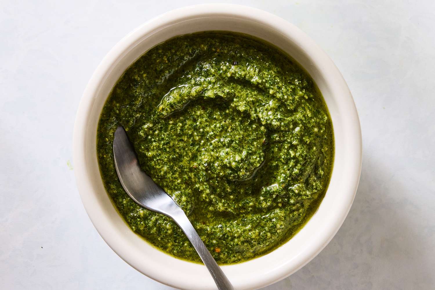 Bowl of pesto with a spoon