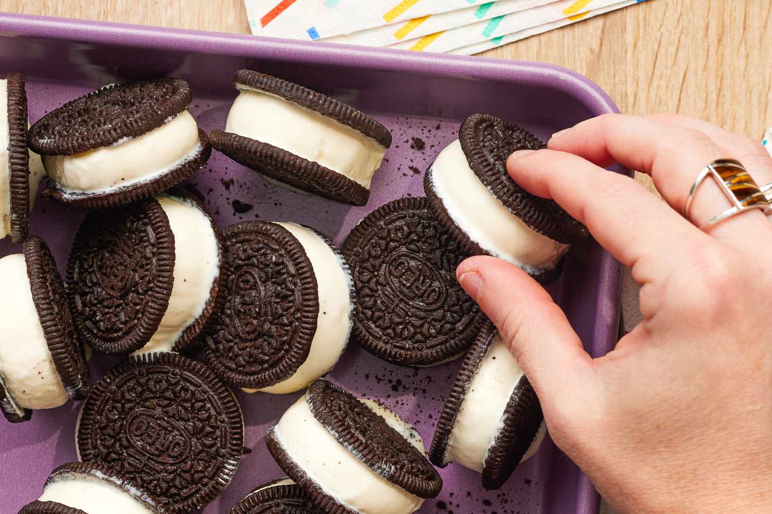 Hand Picking up a 2-Ingredient Ice Cream Sandwich From a Tray With More, and in the Surroundings, Decorative Single Use Napkins